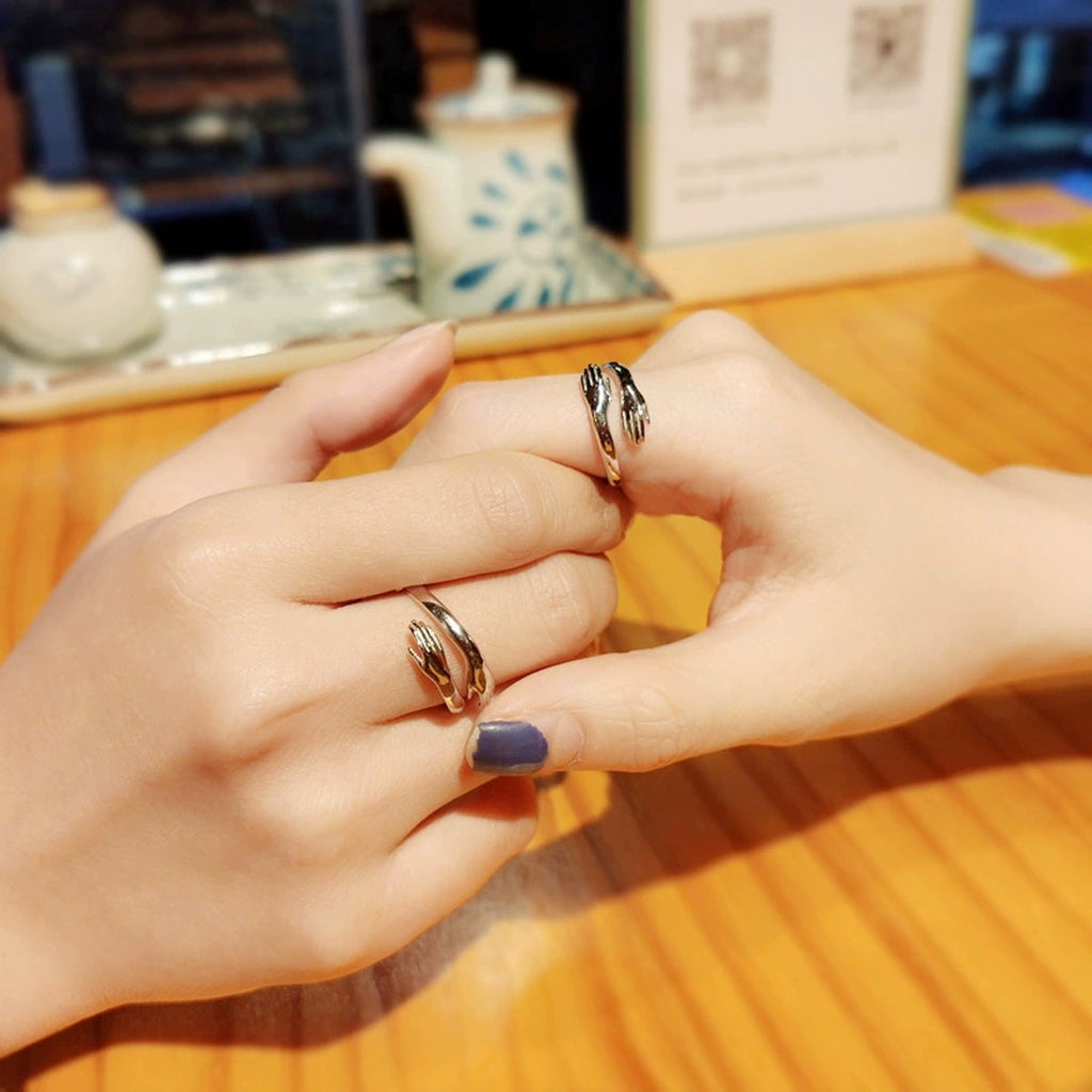 Embrace Motif Couples Adjustable Rings worn on hand to show scale, band width, and ring profile