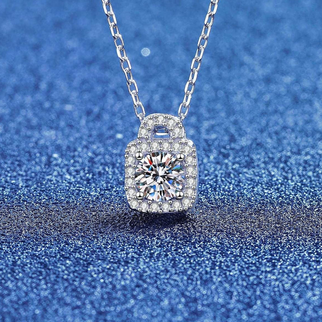 Close-up of a round moissanite lock pendant necklace with pavé halo
