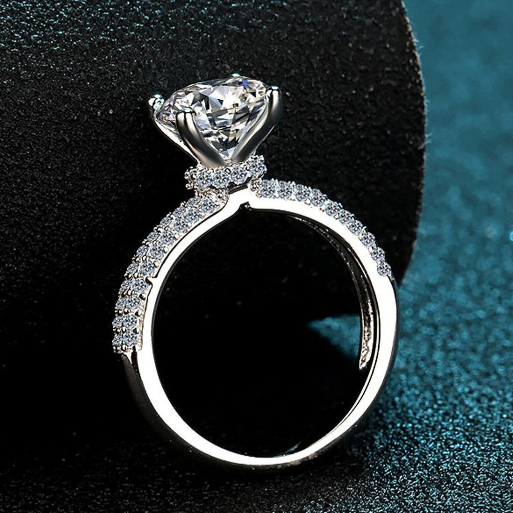 Round Moissanite Side Stone Engagement Ring with CZ product view showing moissanite setting and metal finish