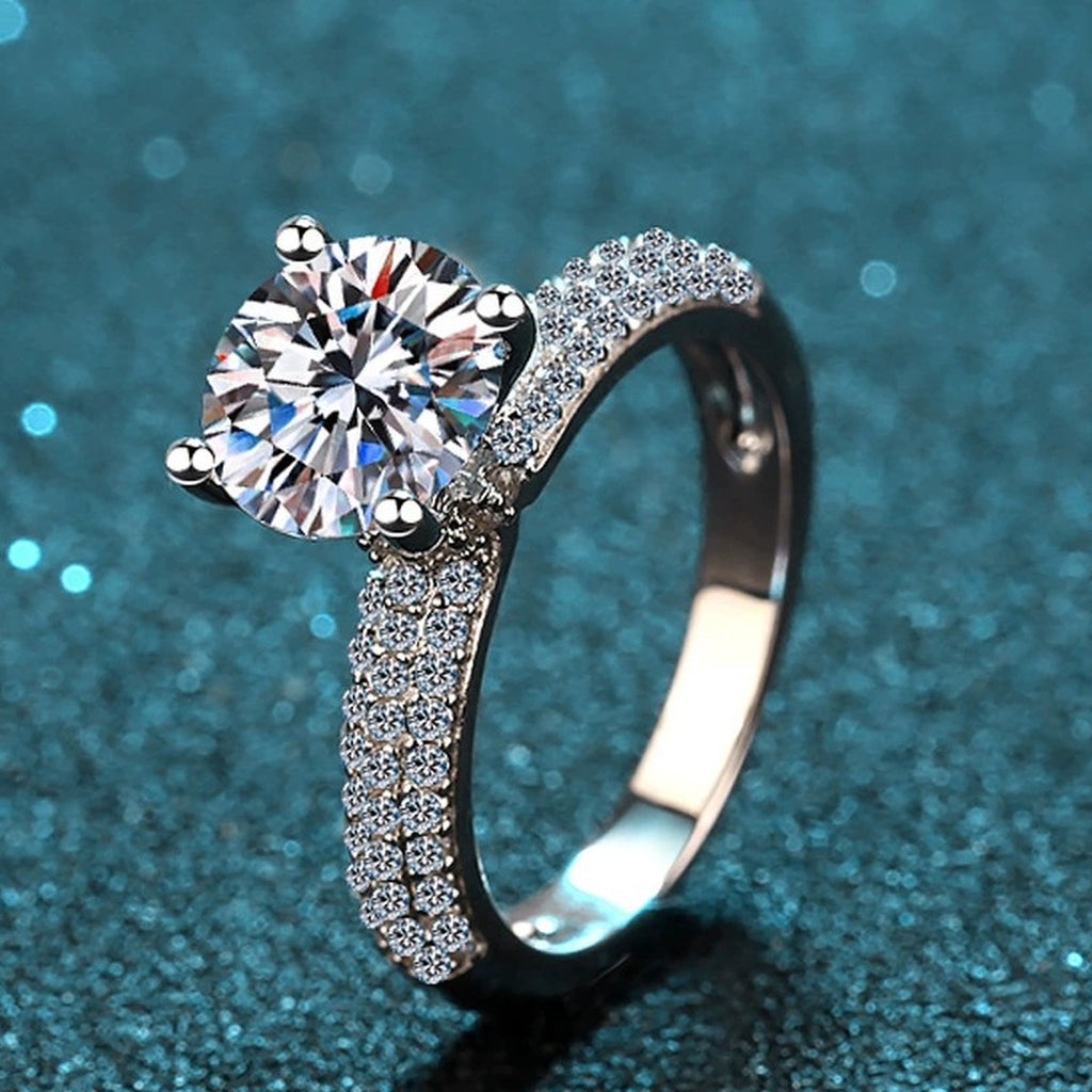 Round Moissanite Side Stone Engagement Ring with CZ product view showing moissanite setting and metal finish