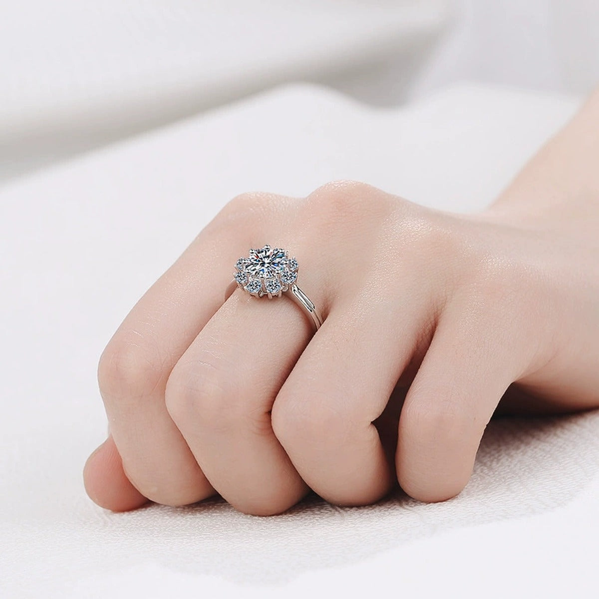 Round Moissanite Side Stone Engagement Ring with CZ worn on hand to show scale, band width, and ring profile