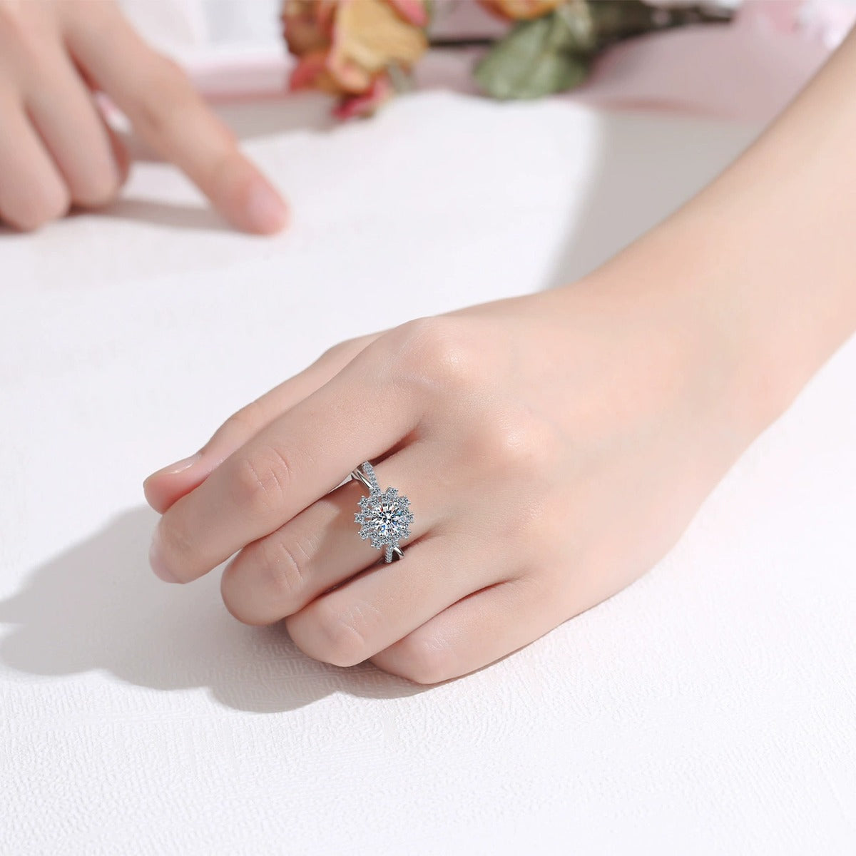 Floral Halo Moissanite Engagement Ring with CZ worn on hand to show scale, band width, and ring profile