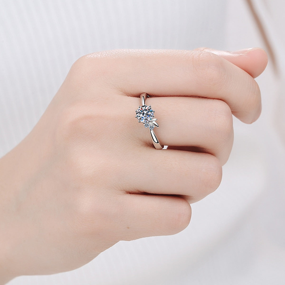 Round Moissanite Side Stone Ring with CZ worn on hand to show scale, band width, and ring profile