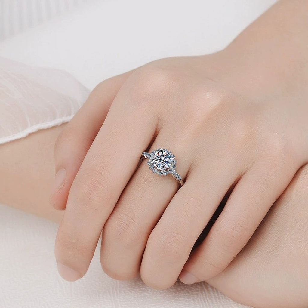Round Moissanite Floral Engagement Ring with CZ worn on hand to show scale, band width, and ring profile