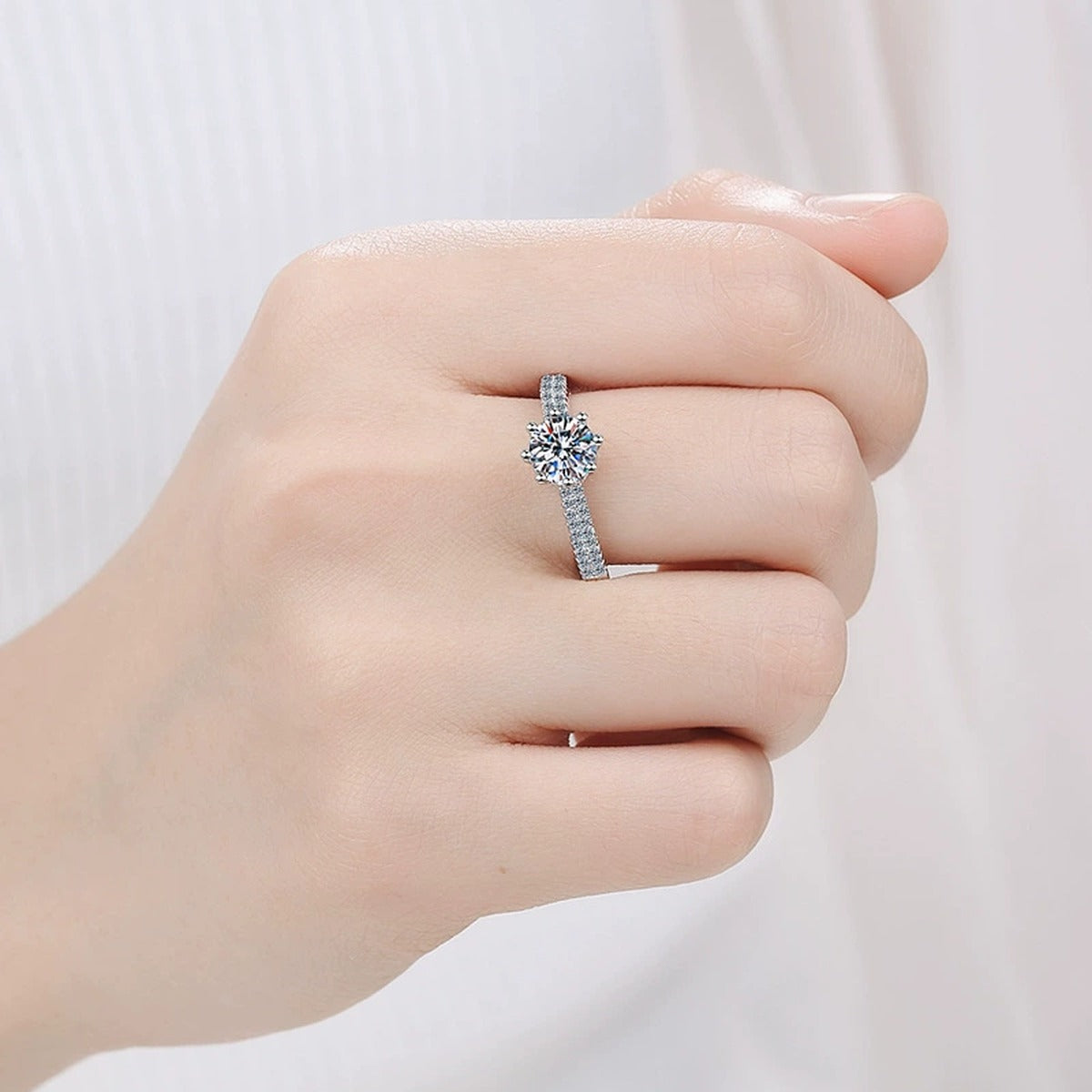 Round Moissanite Pavé Engagement Ring with CZ worn on hand to show scale, band width, and ring profile
