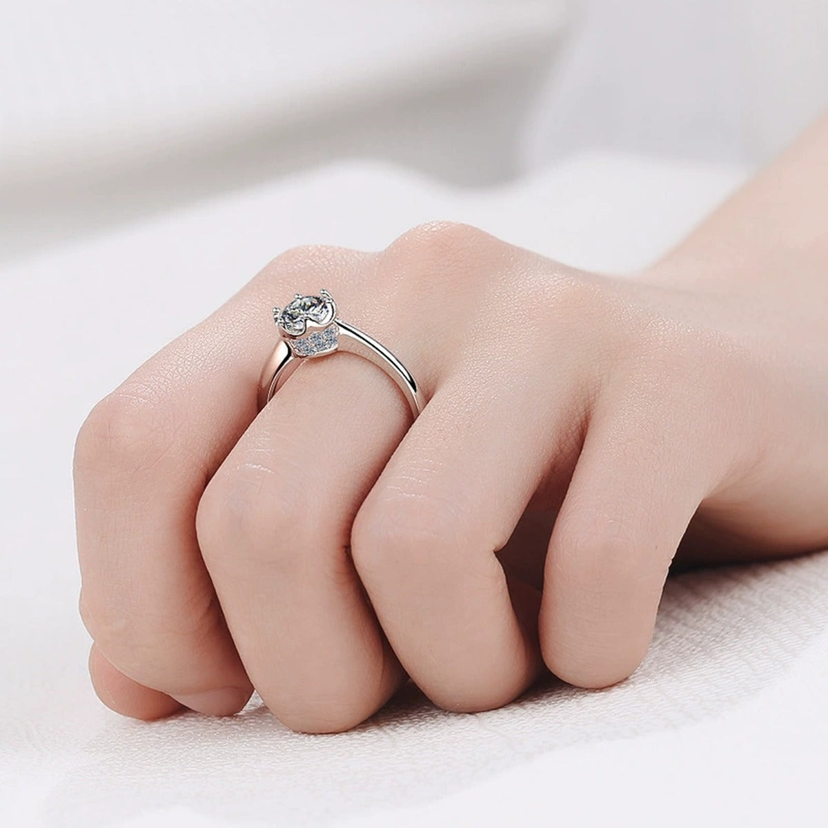 Round Moissanite Solitaire Ring with CZ worn on hand to show scale, band width, and ring profile
