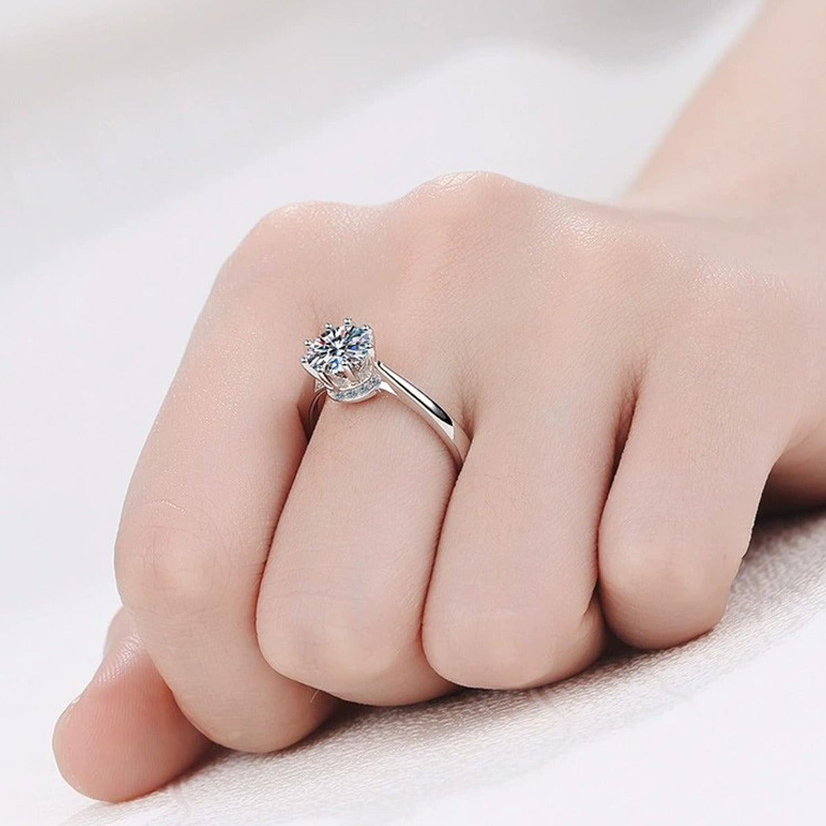 Round Moissanite Side Stone Ring with CZ worn on hand to show scale, band width, and ring profile