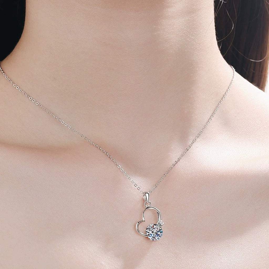 Love Heart Moissanite Pendant Necklace in Rhodium-Plated S925 sterling silver worn on neckline by model showing scale and adjustable chain styling