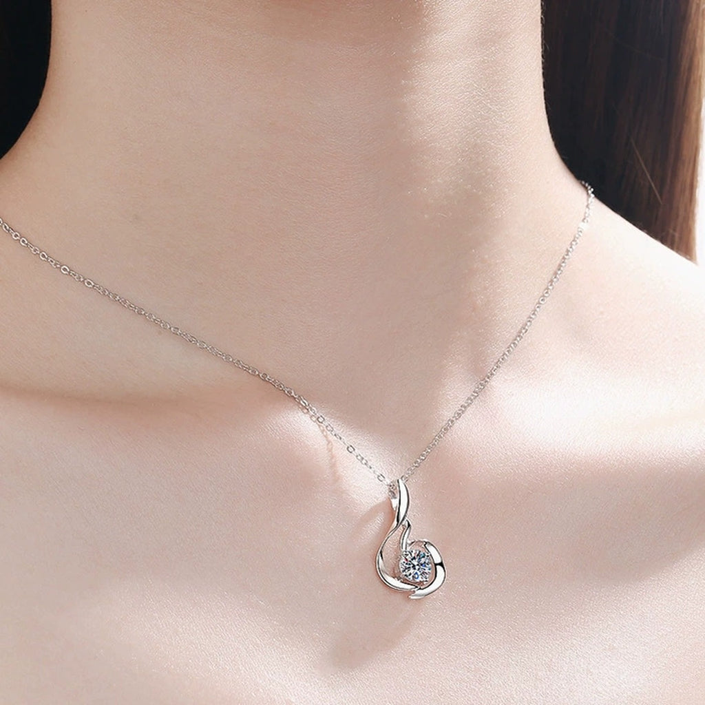 Swirl Moissanite Pendant Necklace in Rhodium-Plated S925 sterling silver worn on neckline by model showing scale and adjustable chain styling