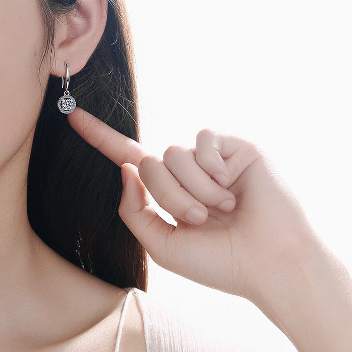 Round Halo Moissanite Hook Dangle Earrings with CZ in Rhodium-Plated S925 Sterling Silver worn on ear by model to show scale, drop length, and everyday styling