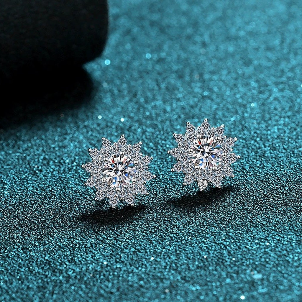 Floral Halo Moissanite Stud Earrings with CZ in Rhodium-Plated S925 Sterling Silver on blue-green fabric showing angled setting view