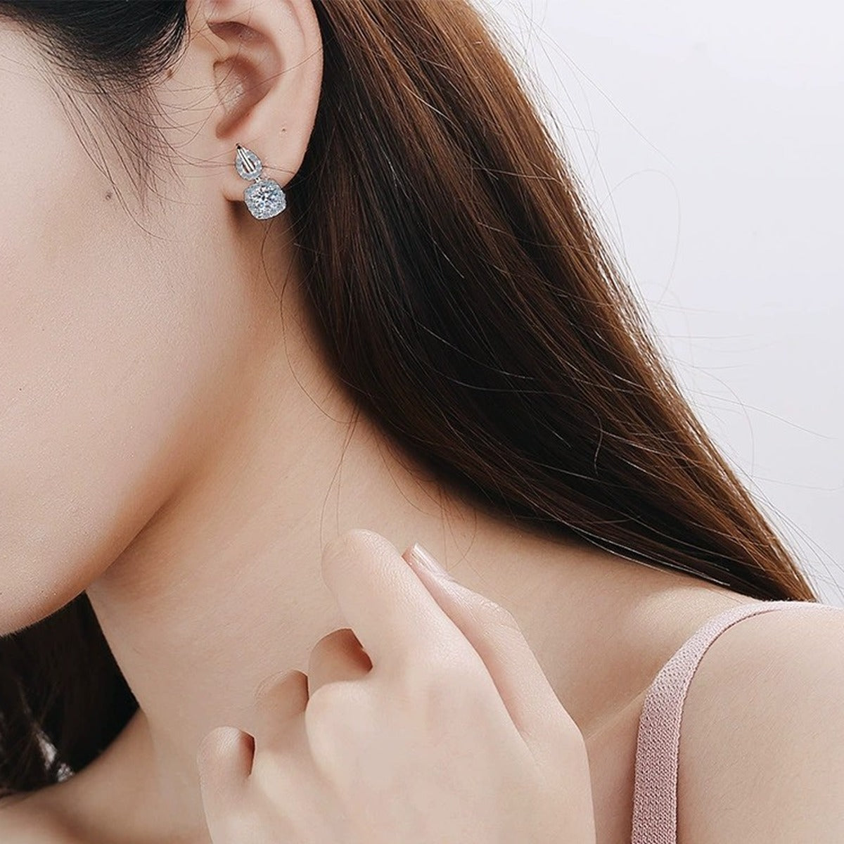 Cushion Halo Moissanite Stud Drop Earrings with CZ in Rhodium-Plated S925 Sterling Silver worn on ear by model to show scale, drop length, and everyday styling