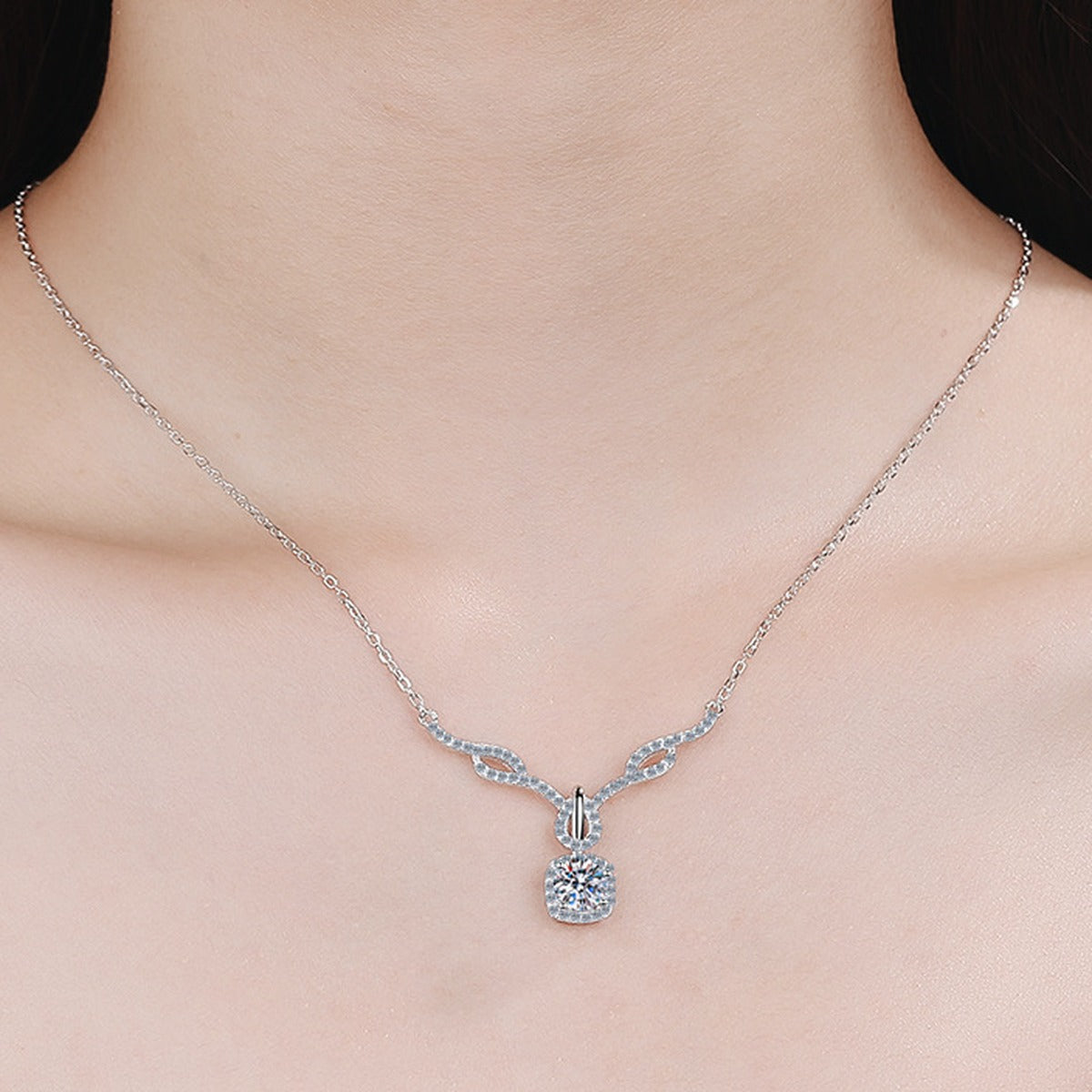 Angel Wing Cushion Moissanite Pendant Necklace with CZ in Rhodium-Plated S925 sterling silver worn on neckline by model showing scale and adjustable chain styling