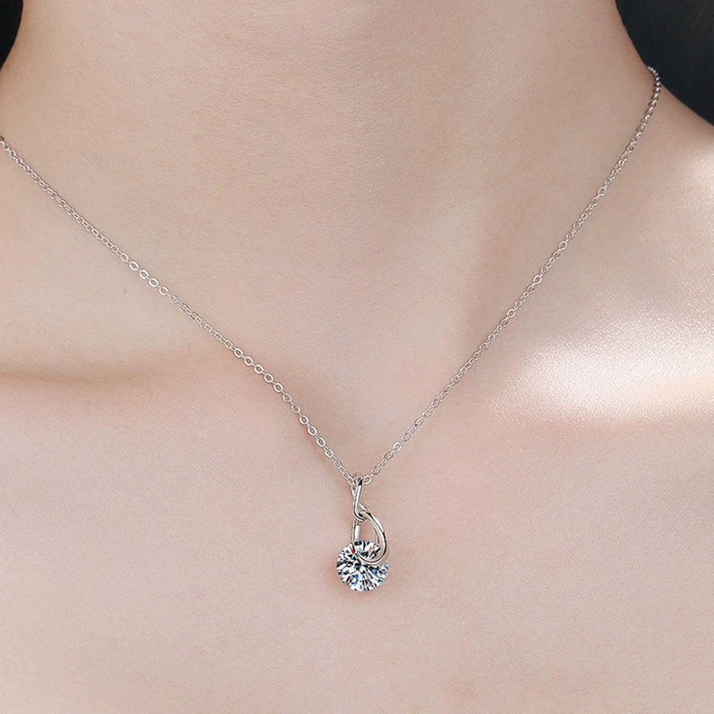 Water Drop Moissanite Pendant Necklace in Rhodium-Plated S925 sterling silver worn on neckline by model showing scale and adjustable chain styling