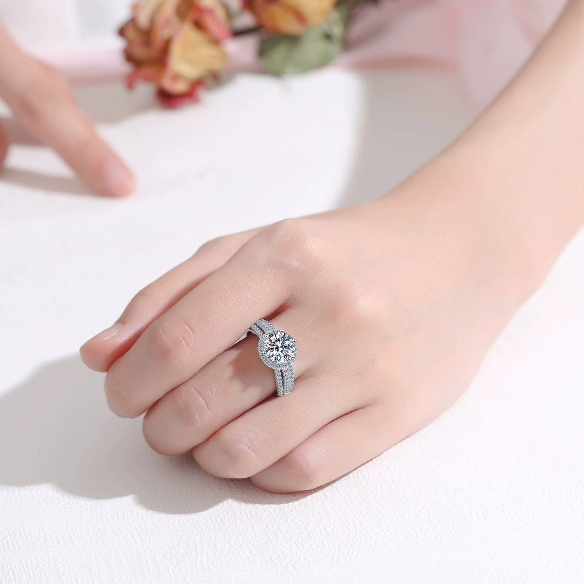 Round Moissanite Side Stone Ring with CZ worn on hand to show scale, band width, and ring profile