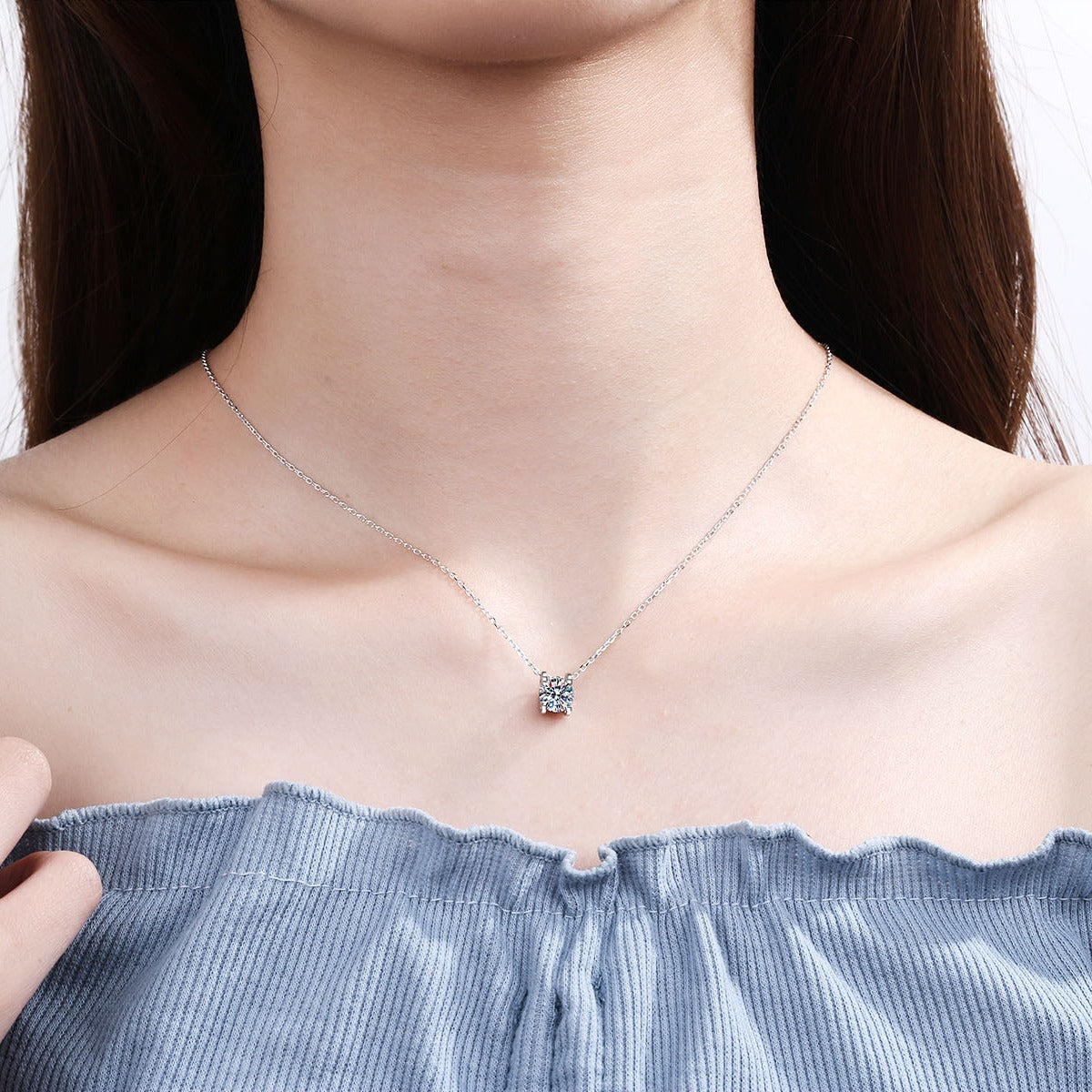 Solitaire and Cross Round Moissanite Pendant Necklace in Rhodium-Plated S925 sterling silver neckline model view showing pendant scale and adjustable chain