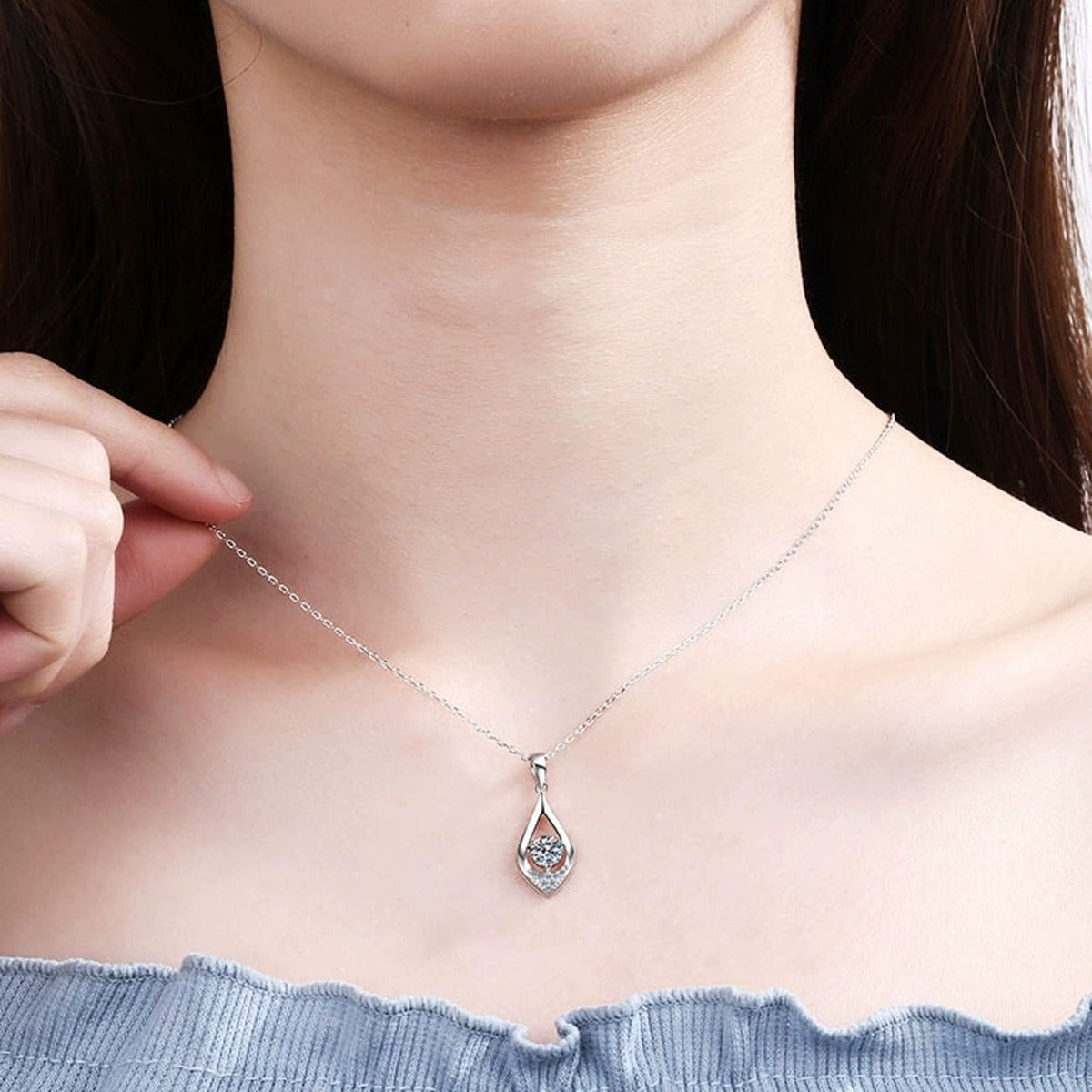 Teardrop Moissanite Pendant Necklace with CZ in Rhodium-Plated S925 sterling silver worn on neckline by model showing scale and adjustable chain styling