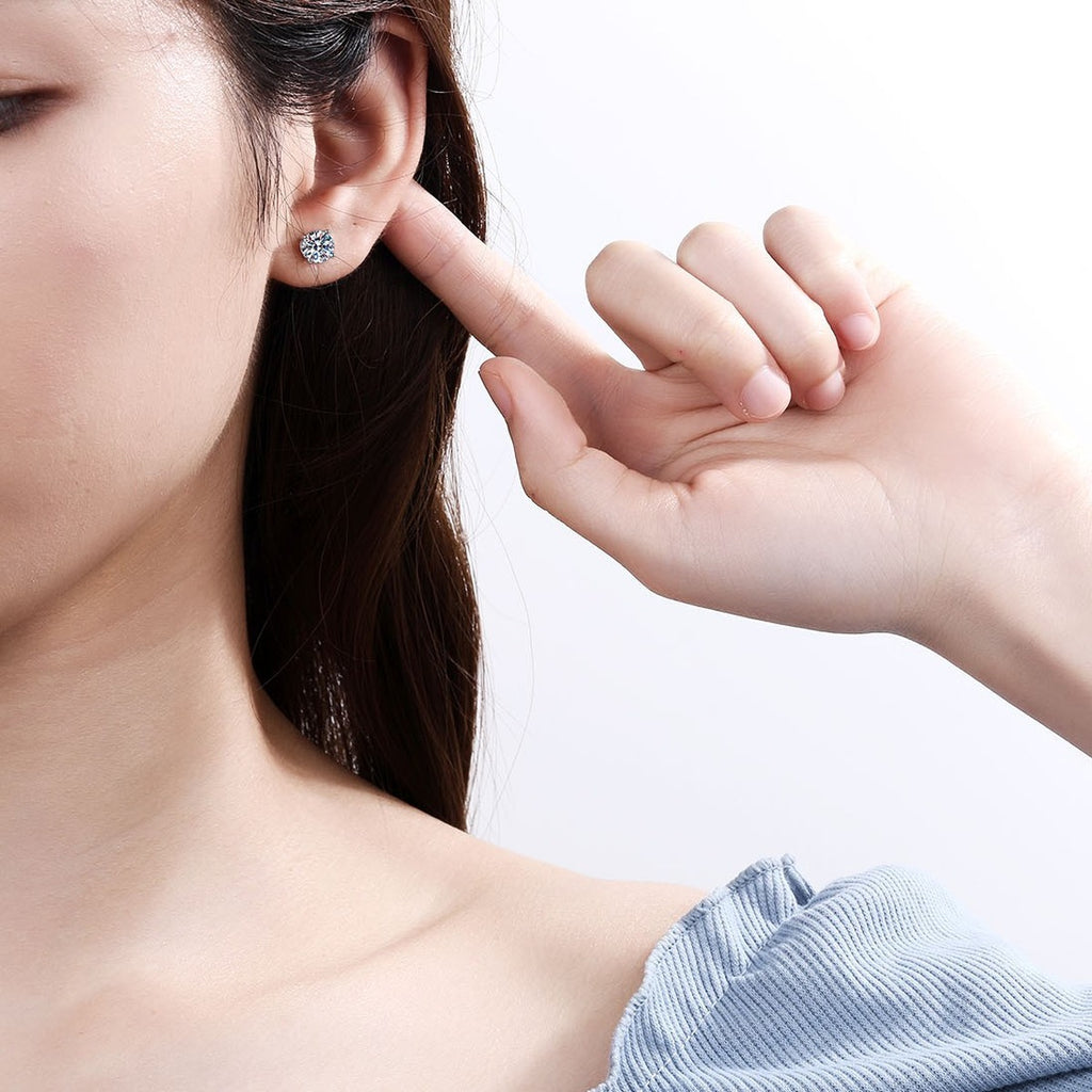 Classic Round Moissanite Stud Earrings in Rhodium-Plated S925 Sterling Silver worn on ear by model to show scale, drop length, and everyday styling