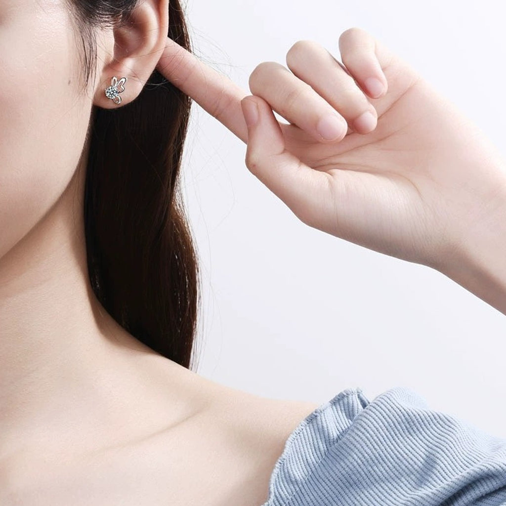Butterfly Moissanite Stud Earrings in Rhodium-Plated S925 Sterling Silver worn on ear by model to show scale, drop length, and everyday styling