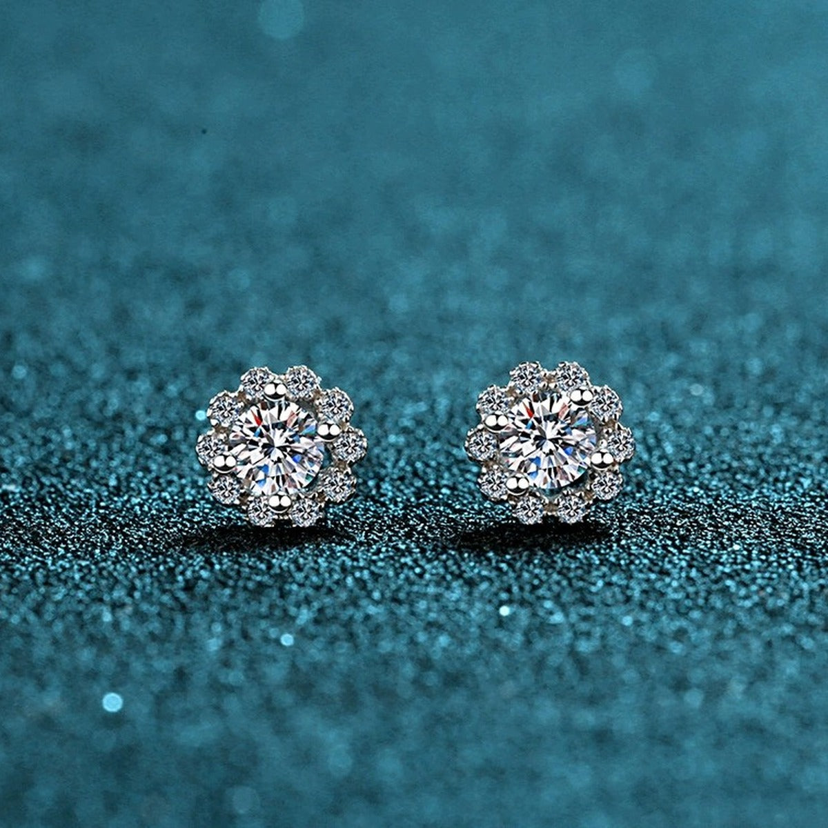 Floral Halo Moissanite Stud Earrings with CZ in Rhodium-Plated S925 Sterling Silver on blue-green fabric showing front detail