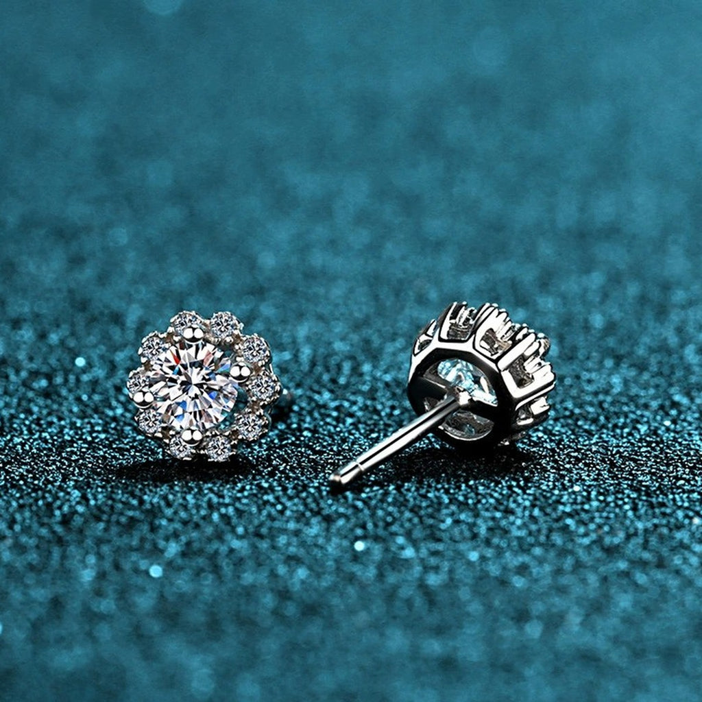 Floral Halo Moissanite Stud Earrings with CZ in Rhodium-Plated S925 Sterling Silver on blue-green fabric showing side profile and stone setting