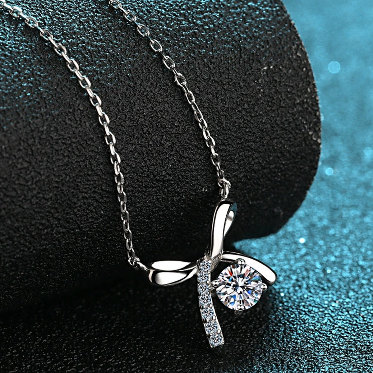 Ribbon Bow Moissanite Pendant Necklace with CZ in Rhodium-Plated S925 sterling silver product scene view showing angled sparkle