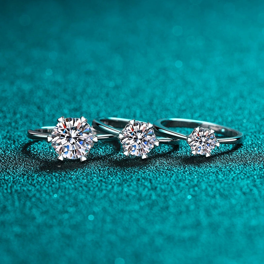 Round Moissanite Six-Prong Solitaire Ring worn on hand to show scale, band width, and ring profile