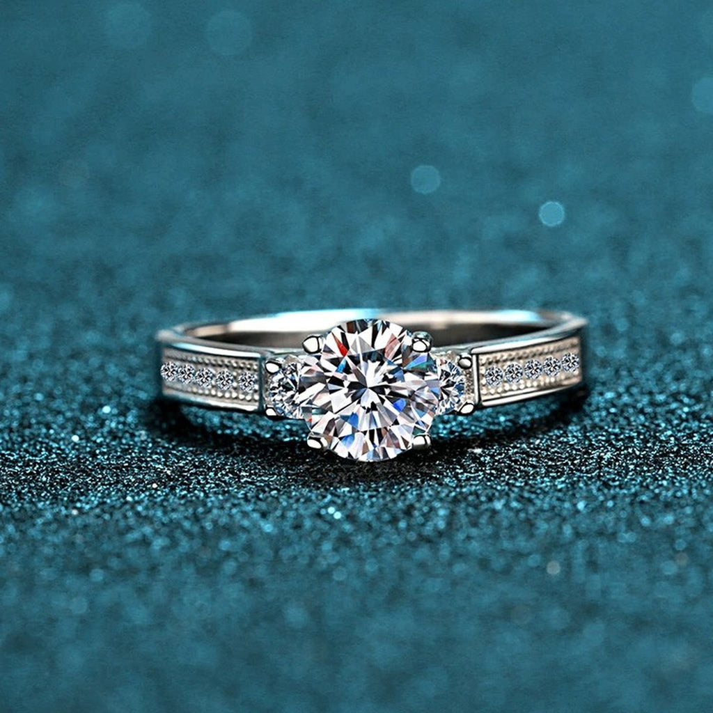Round Moissanite Side Stone Engagement Ring with CZ product view showing moissanite setting and metal finish