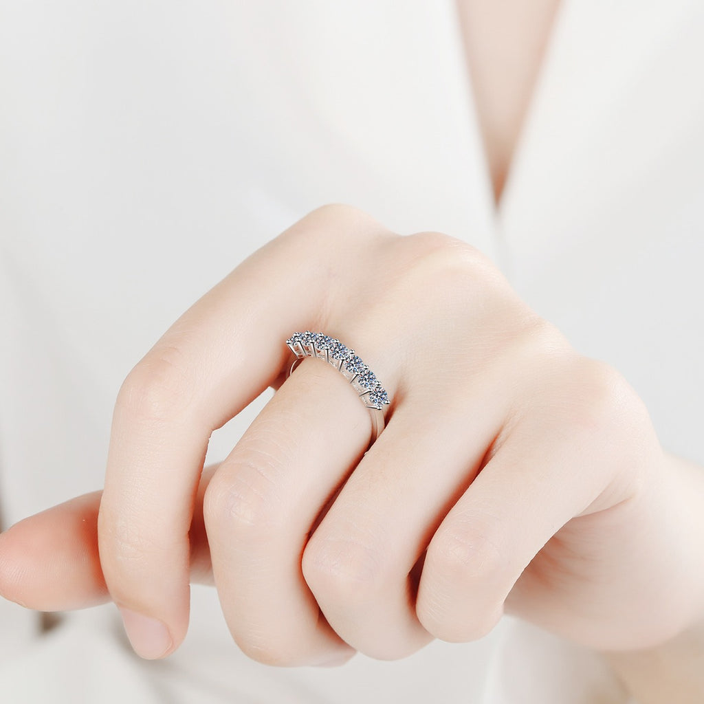 Curved Pave Moissanite Band Ring in Rhodium-Plated S925 Sterling Silver worn on hand, showing scale, finger coverage, and rhodium-plated finish