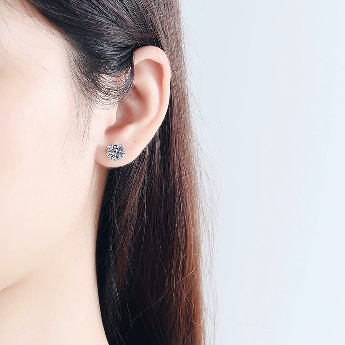 Round Moissanite Stud Earrings in Rhodium-Plated S925 Sterling Silver worn on ear by model to show scale, drop length, and everyday styling