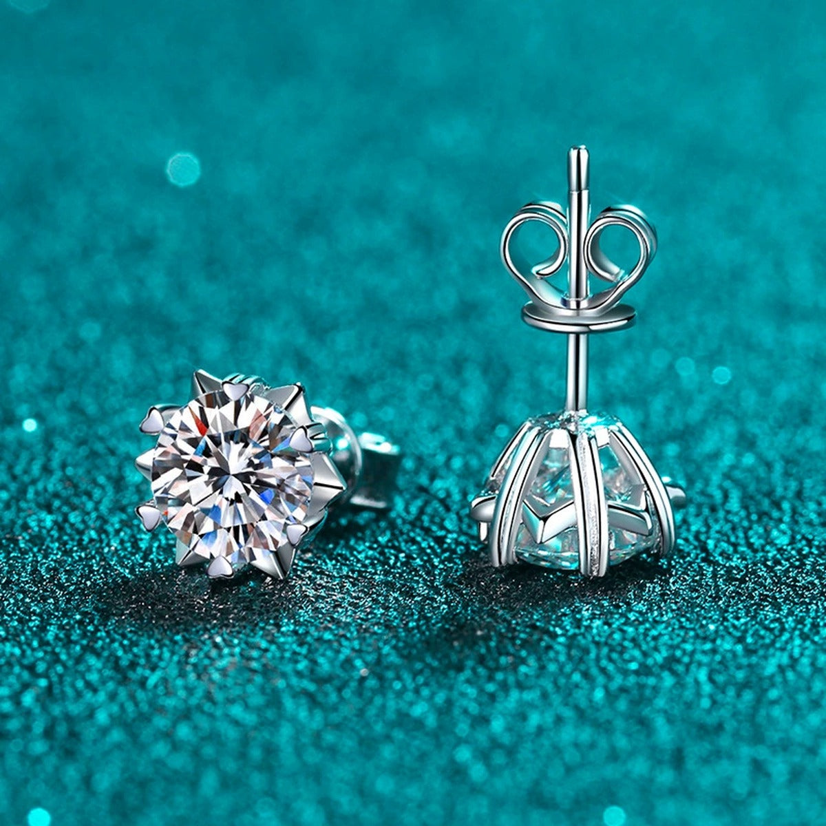 Round Moissanite Stud Earrings in Rhodium-Plated S925 Sterling Silver on blue-green fabric showing front detail