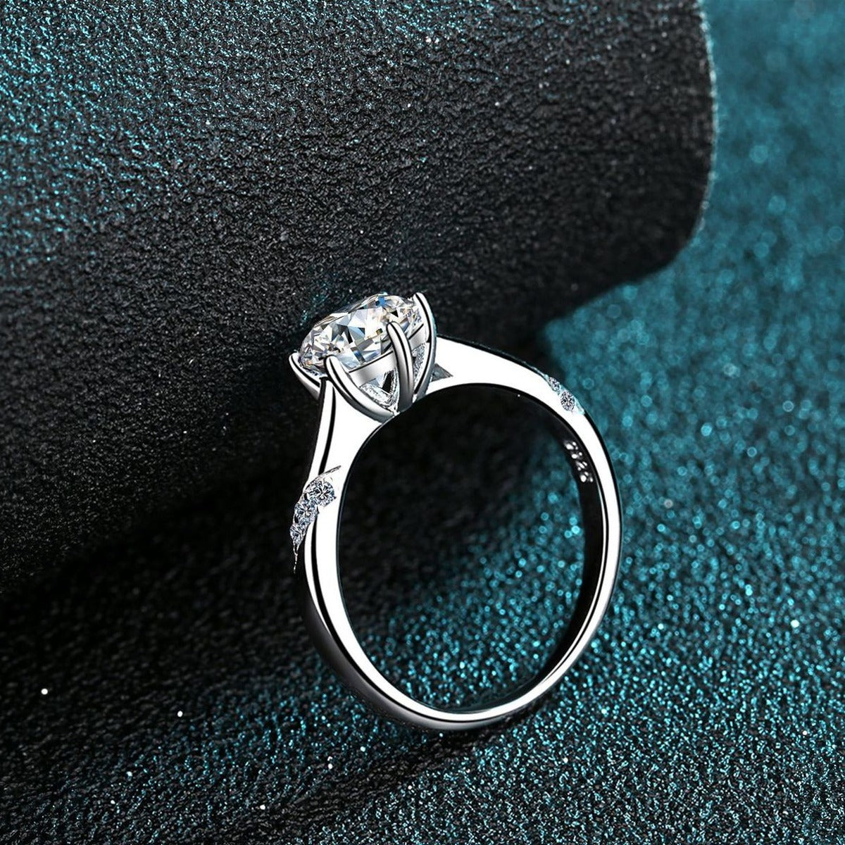 Round Moissanite Solitaire Ring in Rhodium-Plated S925 Sterling Silver blue display product photo showing the moissanite setting and band profile