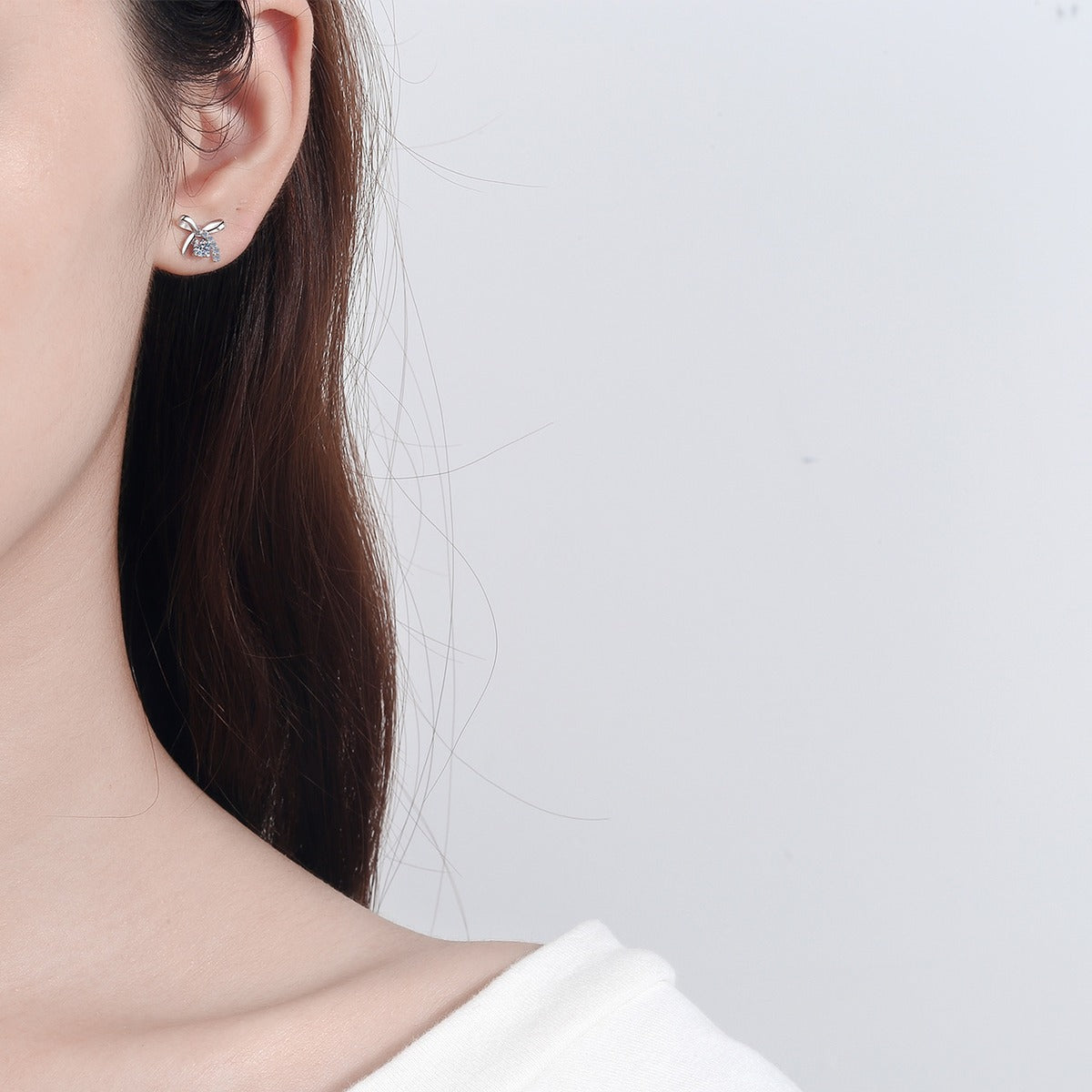 Bow Moissanite Stud Earrings with CZ in Rhodium-Plated S925 Sterling Silver worn on ear by model to show scale, drop length, and everyday styling