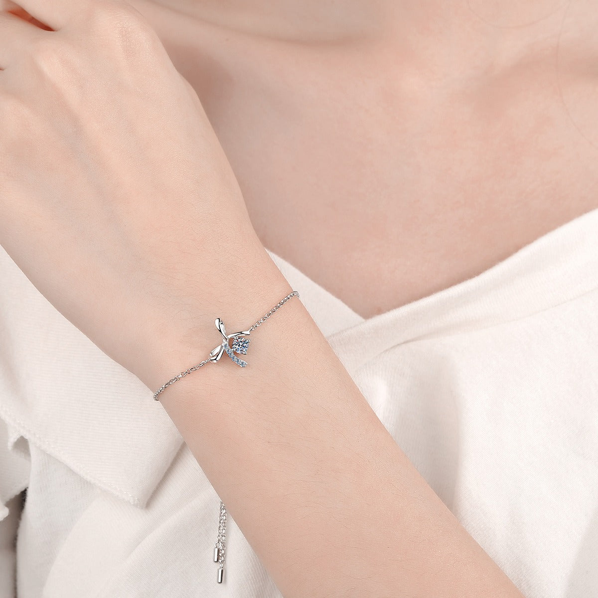 Bow Moissanite Adjustable Bracelet with CZ in Rhodium-Plated S925 sterling silver worn on wrist model view showing scale and adjustable fit