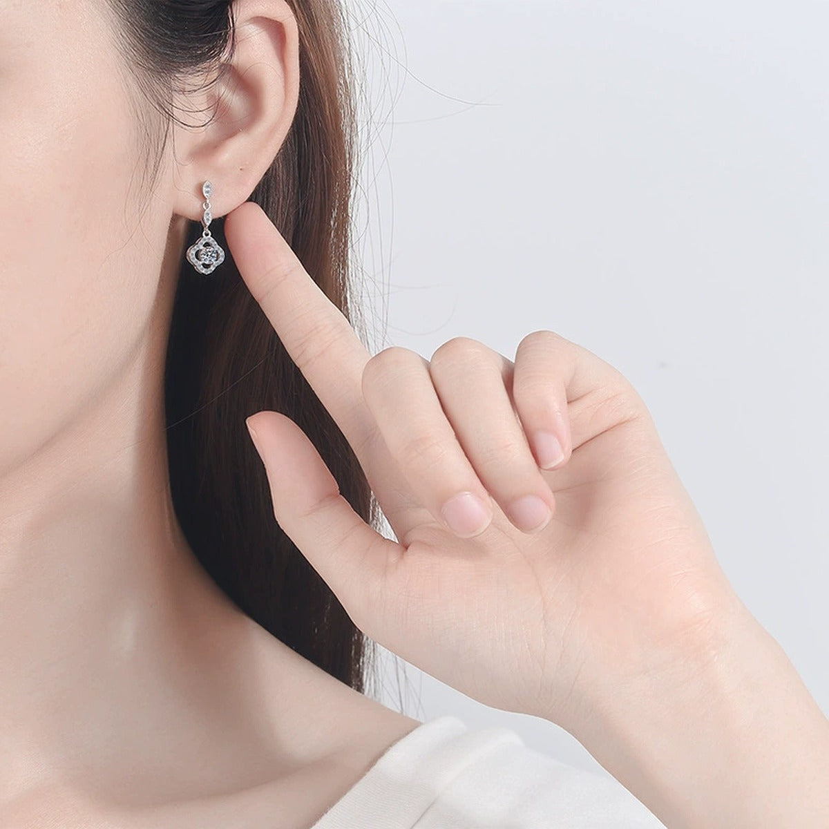 Clover Moissanite Stud Dangle Earrings with CZ in Rhodium-Plated S925 Sterling Silver worn on ear by model to show scale, drop length, and everyday styling