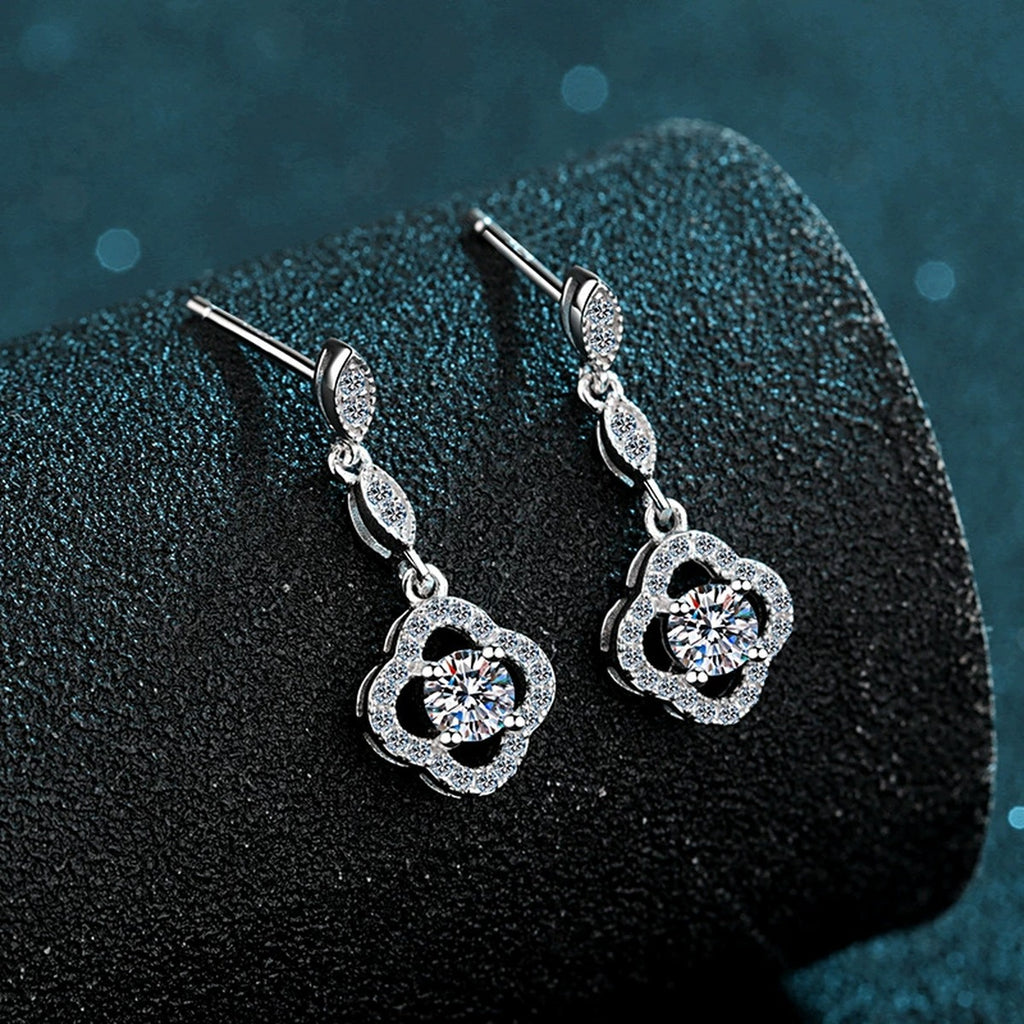 Clover Moissanite Stud Dangle Earrings with CZ in Rhodium-Plated S925 Sterling Silver on blue-green fabric showing front detail