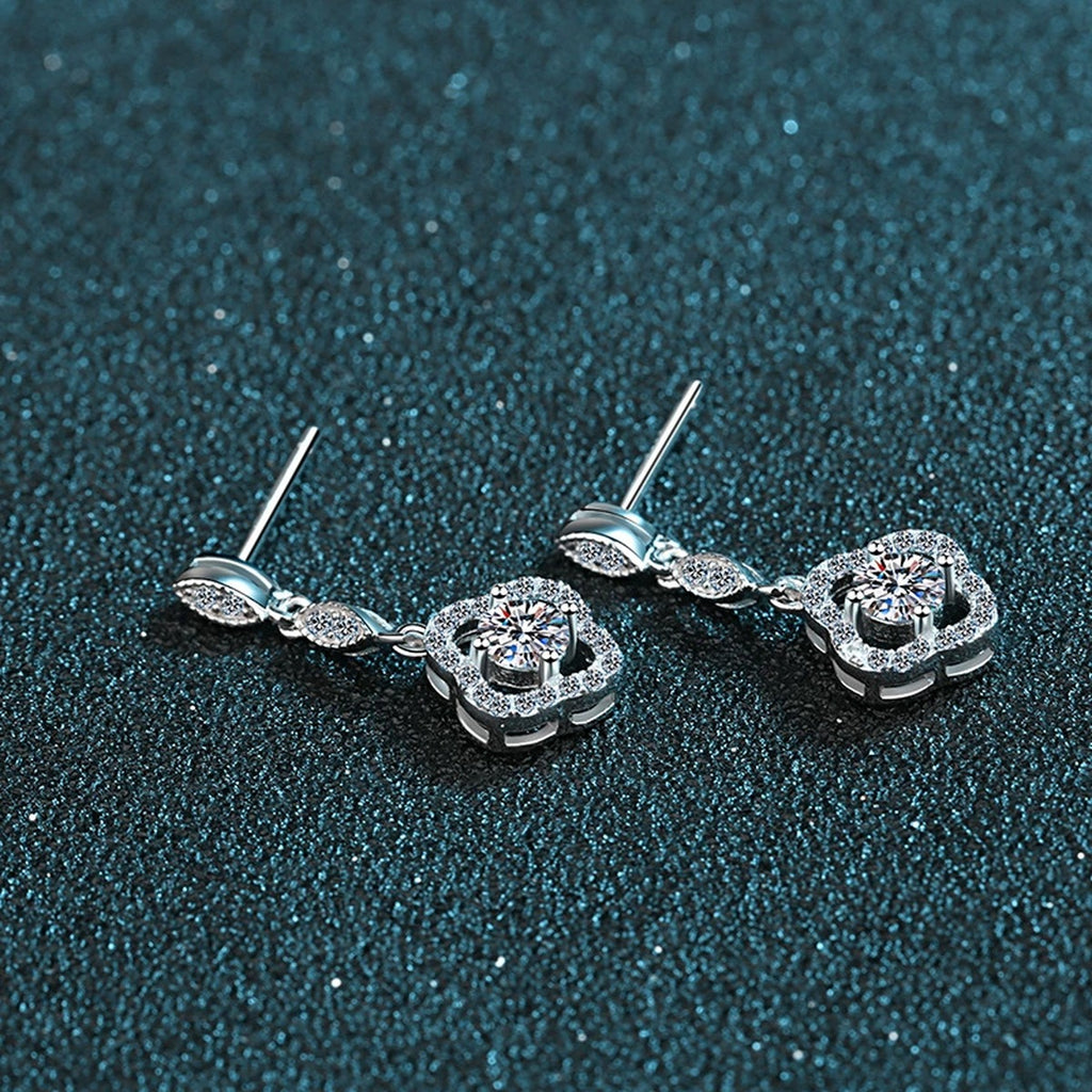 Clover Moissanite Stud Dangle Earrings with CZ in Rhodium-Plated S925 Sterling Silver on blue-green fabric showing angled setting view