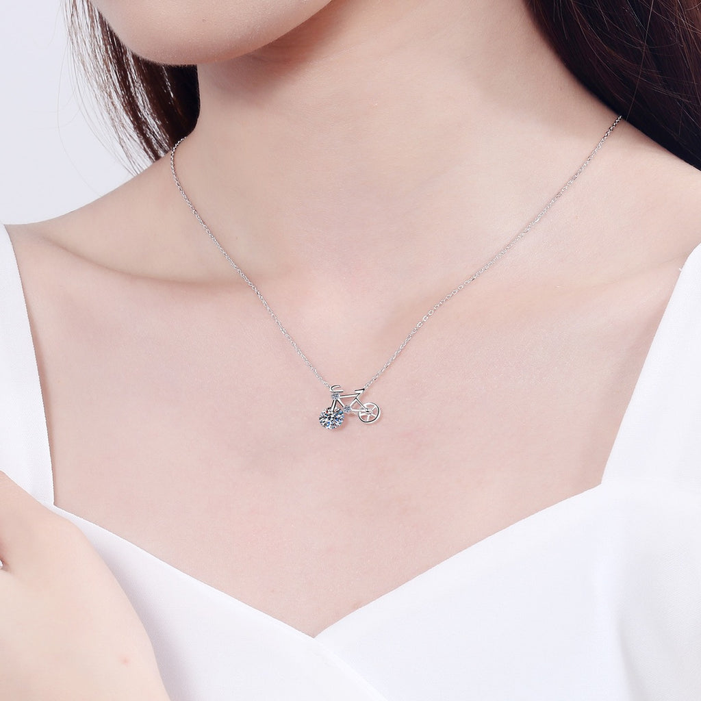 Bicycle Moissanite Pendant Necklace with CZ in Rhodium-Plated S925 sterling silver worn on neckline by model showing scale and adjustable chain styling