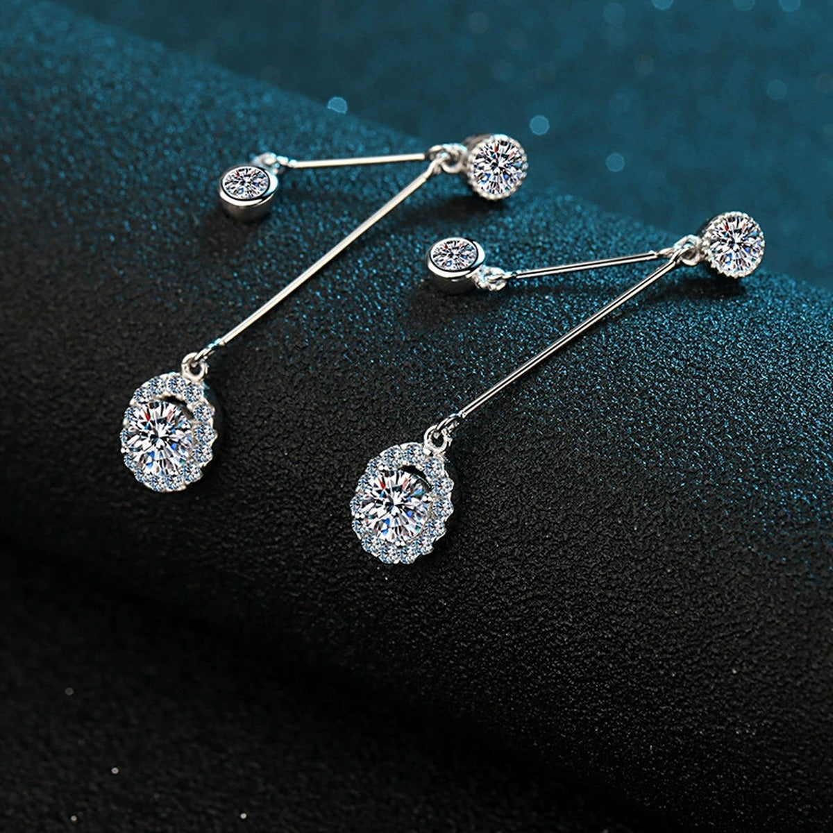 Linear Moissanite Stud Dangle Earrings with CZ in Rhodium-Plated S925 Sterling Silver on blue-green fabric showing front detail