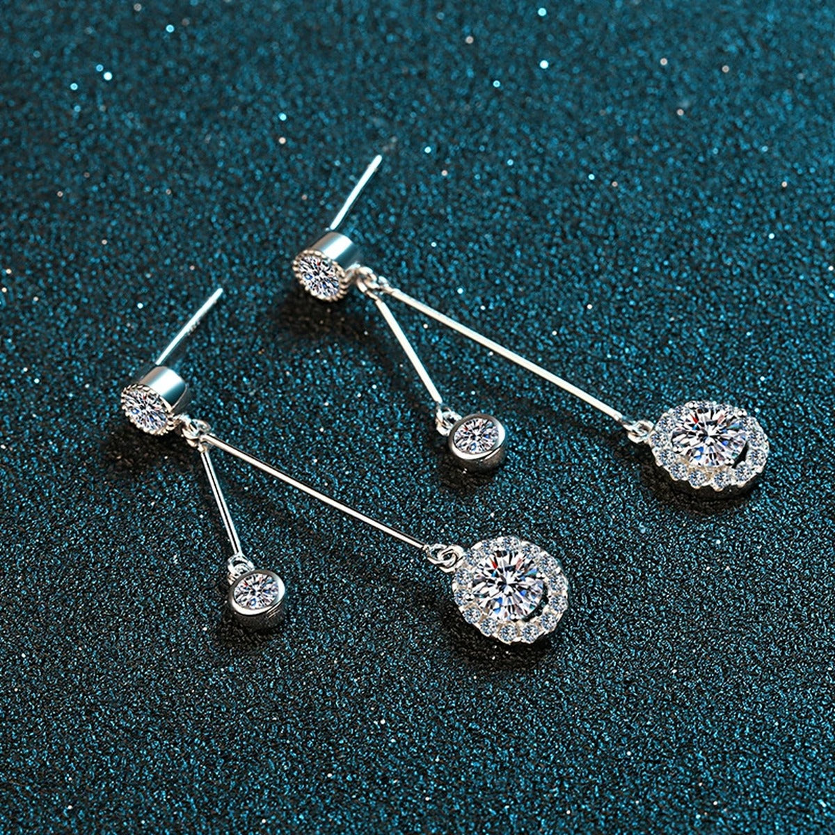 Linear Moissanite Stud Dangle Earrings with CZ in Rhodium-Plated S925 Sterling Silver on blue-green fabric showing angled setting view
