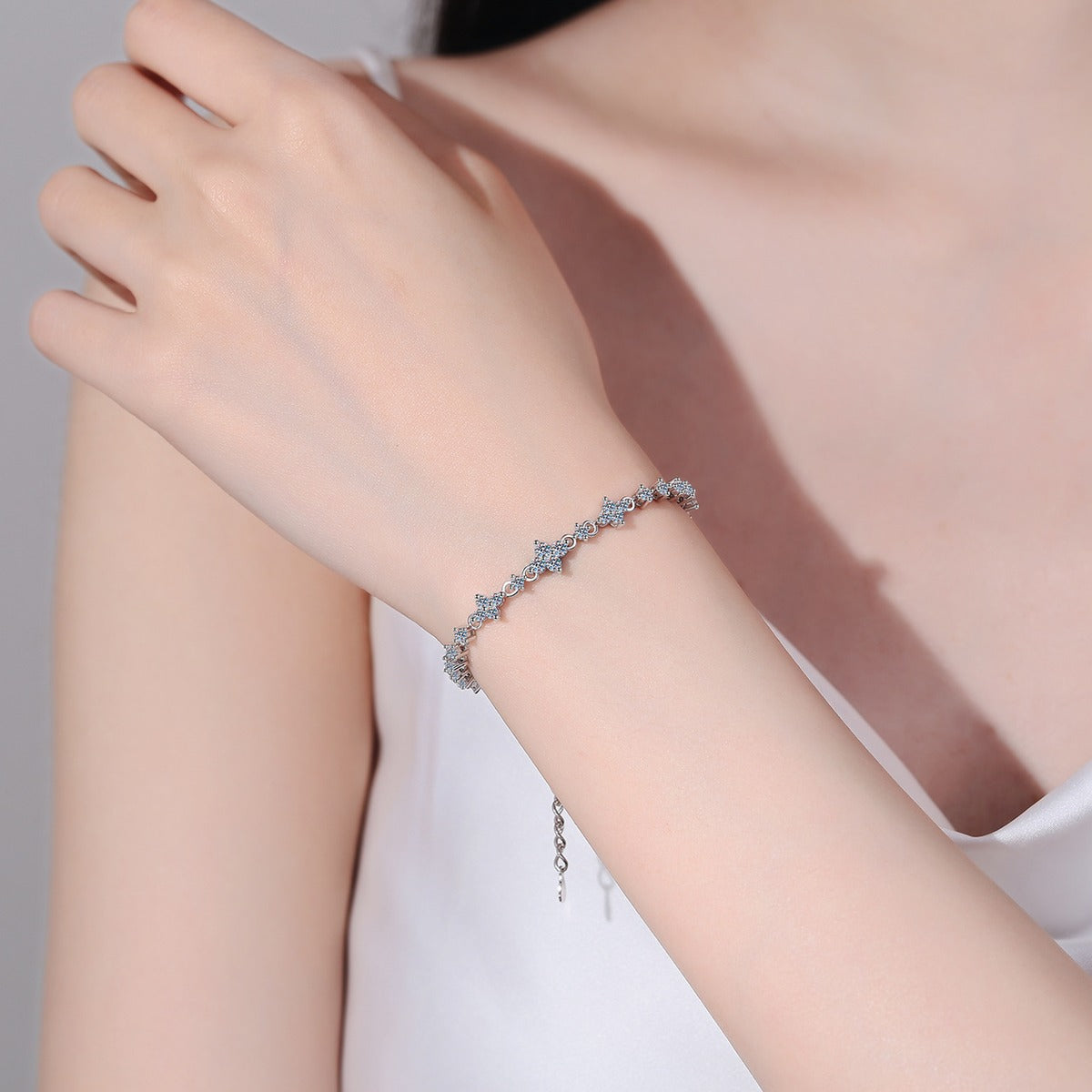 Four-Leaf Clover Moissanite Tennis Bracelet in Rhodium-Plated S925 sterling silver worn on wrist model view showing scale and adjustable fit