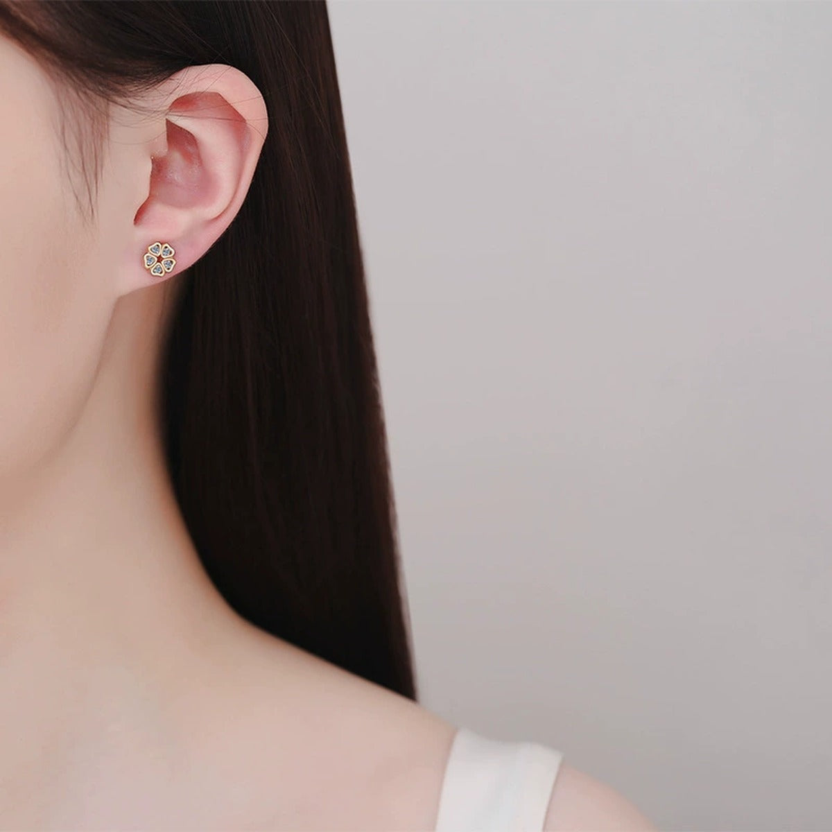 Floral Moissanite Stud Earrings in Champion Gold-Plated S925 sterling silver worn on ear by model showing scale, placement, and stud earrings styling