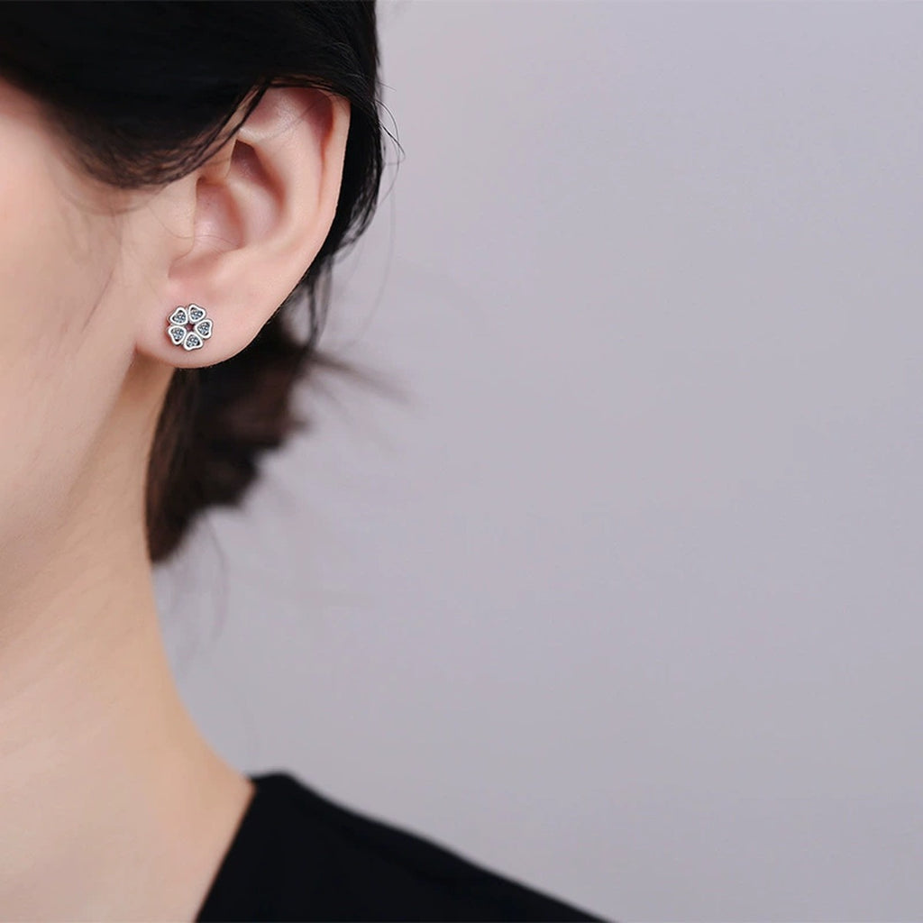 Floral Moissanite Stud Earrings in Rhodium-Plated S925 sterling silver worn on ear by model showing scale, placement, and stud earrings styling