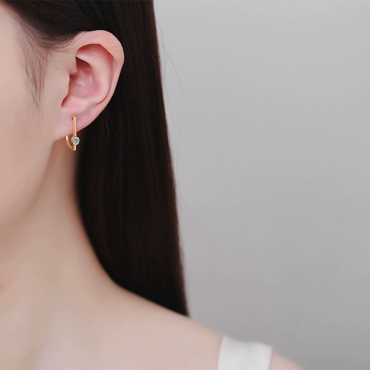 Round Moissanite Stud Drop Earrings in Champion Gold-Plated S925 sterling silver worn on ear by model showing scale, placement, and stud earrings styling