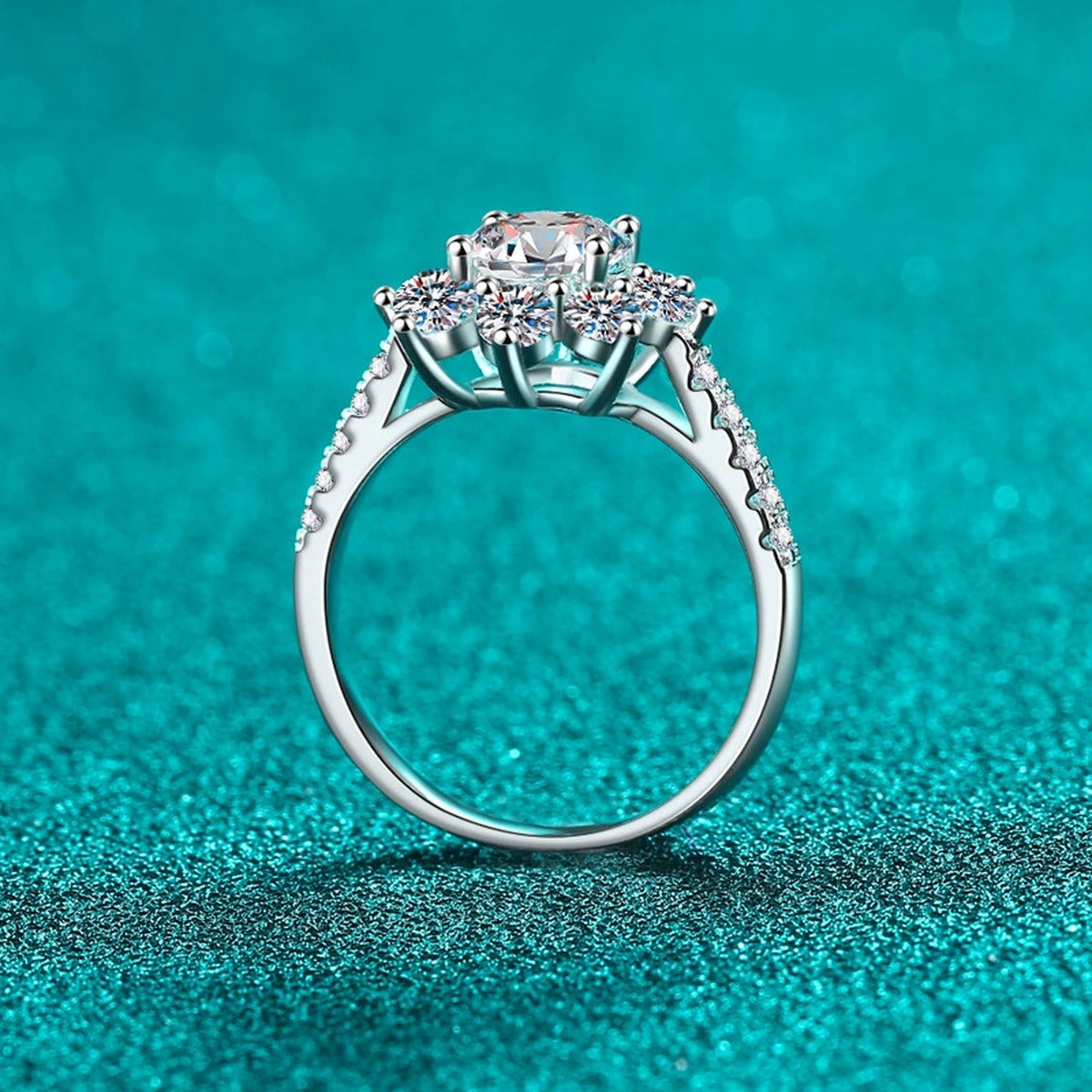Round Moissanite Side Stone Engagement Ring with CZ in Rhodium-Plated S925 Sterling Silver blue display product photo showing the moissanite setting, stone cut, and band profile