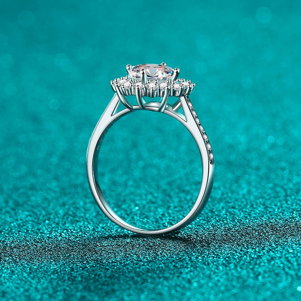 Round Moissanite Side Stone Ring with CZ in Rhodium-Plated S925 Sterling Silver blue display product photo showing the moissanite setting, stone cut, and band profile