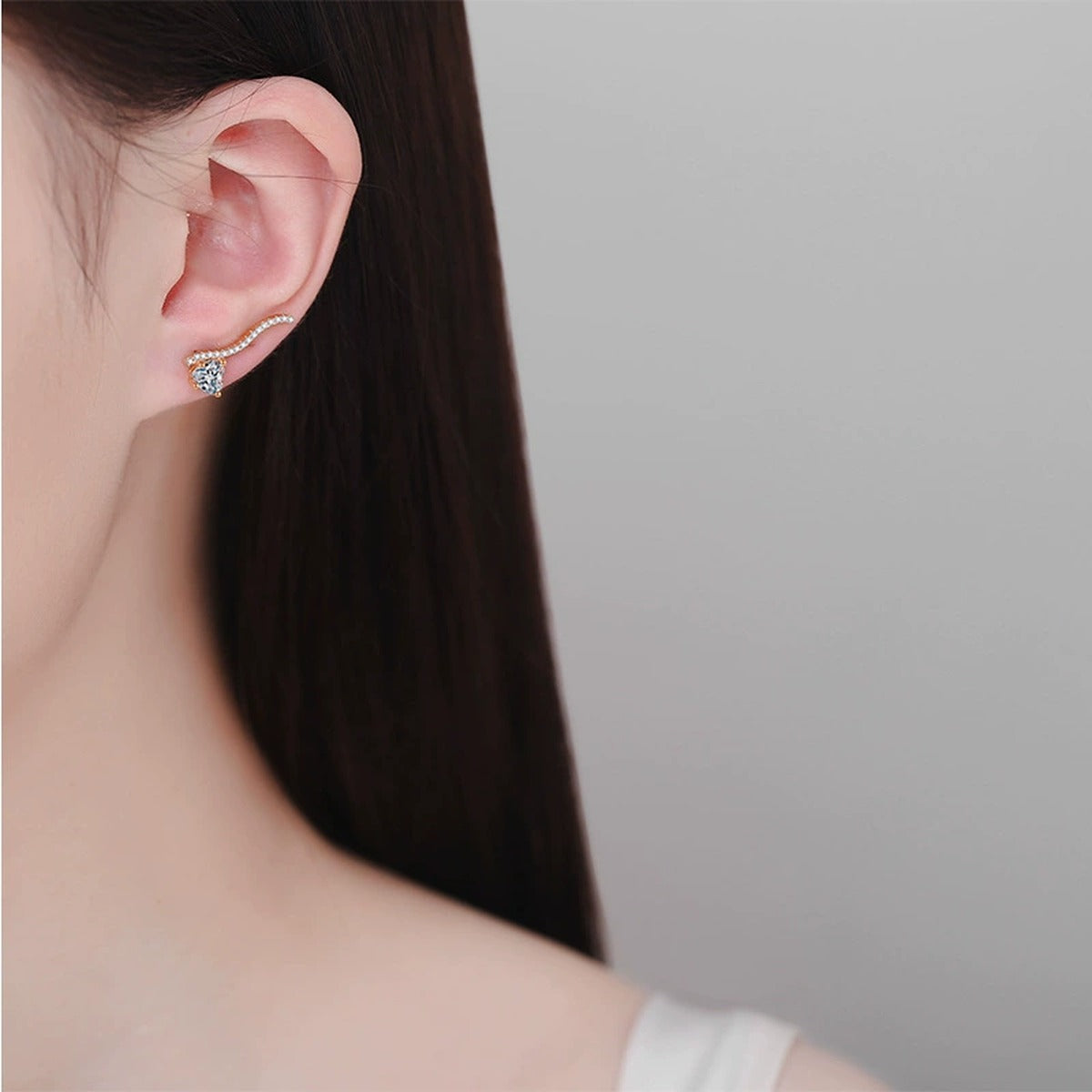 Heart Moissanite Hook Ear Climber Earrings with CZ in Champion Gold-Plated S925 sterling silver worn on ear by model showing scale, placement, and earrings styling