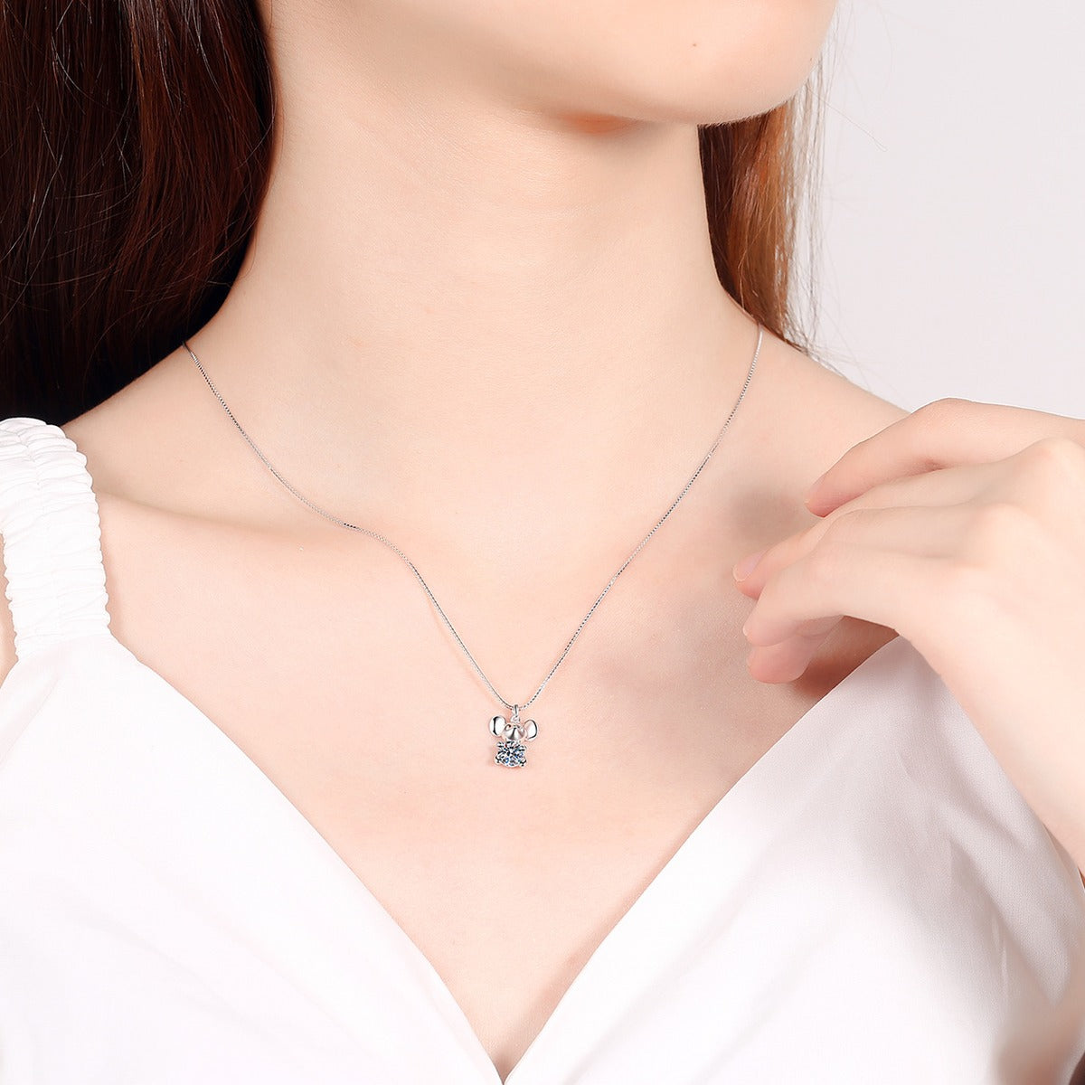 Mouse Moissanite Pendant Necklace in Rhodium-Plated S925 sterling silver worn on neckline by model showing scale and adjustable chain styling