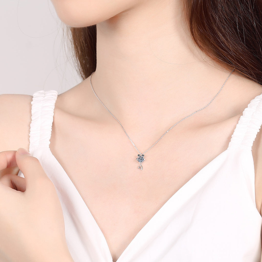 Fish Moissanite Pendant Necklace with CZ in Rhodium-Plated S925 sterling silver worn on neckline by model showing scale and adjustable chain styling