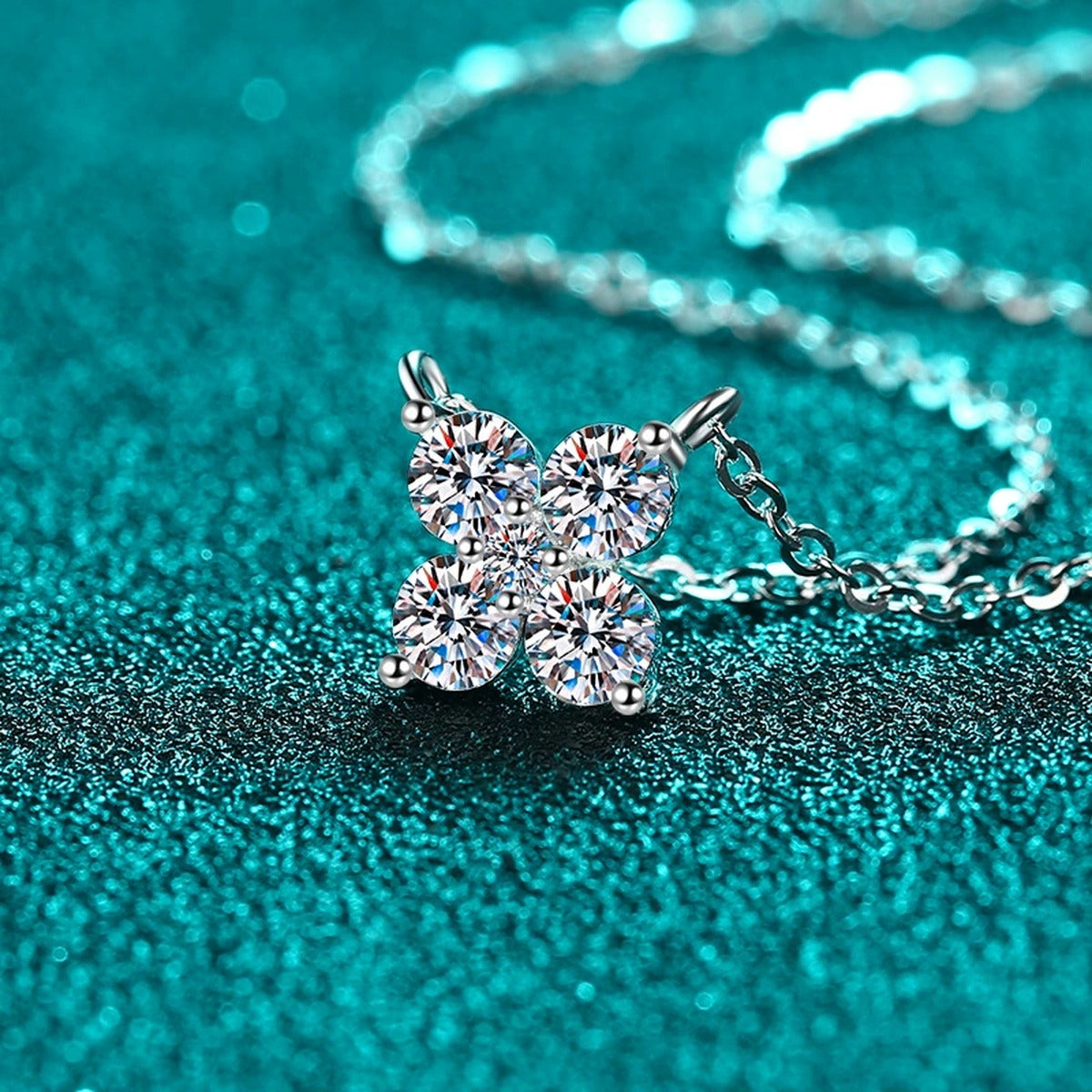 Clover Round Moissanite Necklace in Rhodium-Plated S925 sterling silver blue display scene showing chain and stone layout